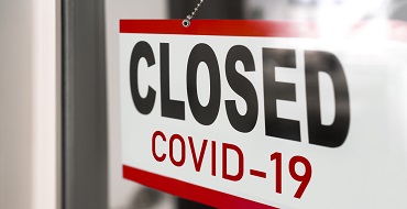 Closed COVID-19 sign on a window