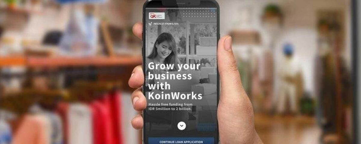 A phone with KoinWorks's mobile app