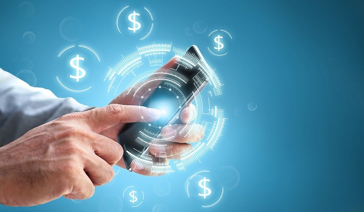 Business man hand holding a phone with currency signs on blue background