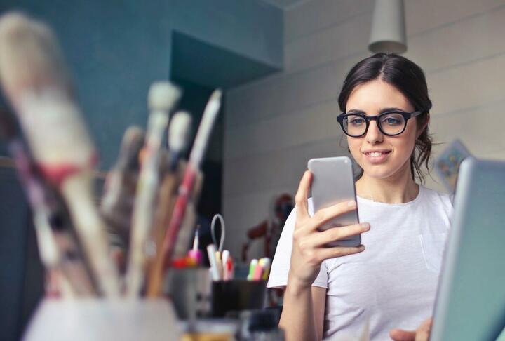 Article Cover of a girl using her phone and laptop in Color