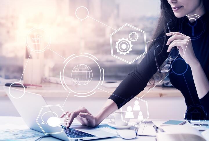 Woman sitting on a computer with a background of tech icons