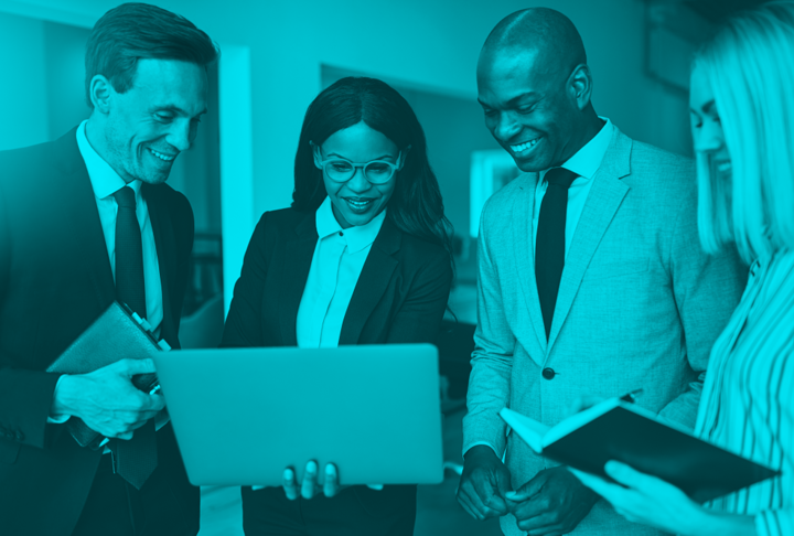 Black business woman with computer surrounded by male and female coworkers