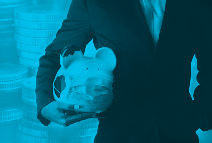 Man in suit, holding a piggy bank with mask and coins in the background