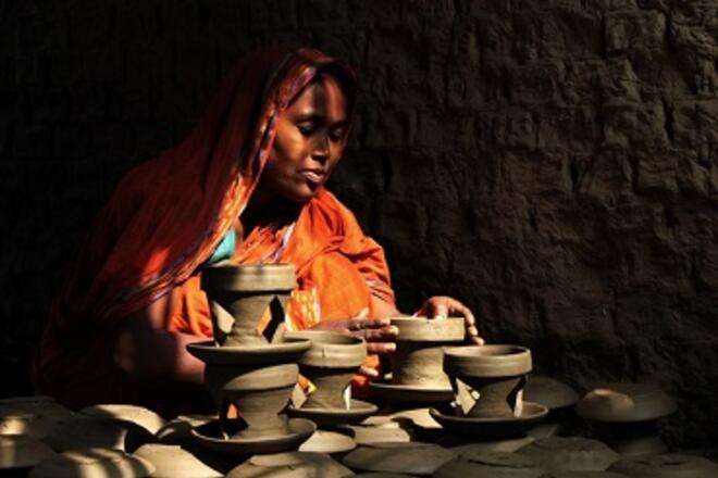 An entrepreneur in Bangladesh puts the finishing touches on her clay pots. Photo: Moksumul Haque, 2015 CGAP Photo Contest