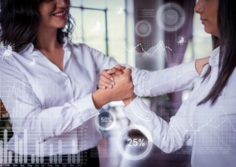two women shaking hands with financial graphs as filter